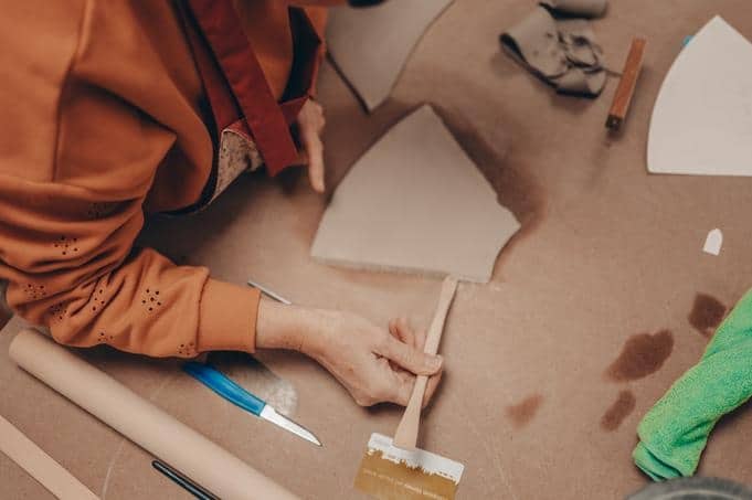 An elephant being sculpted from clay by hand