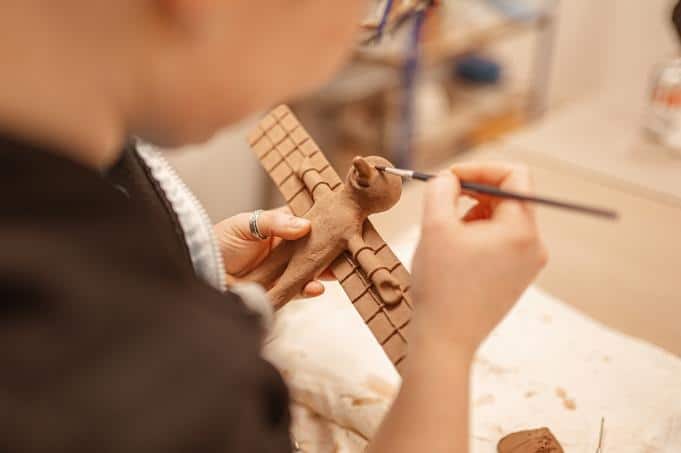 An elephant being sculpted from clay by hand